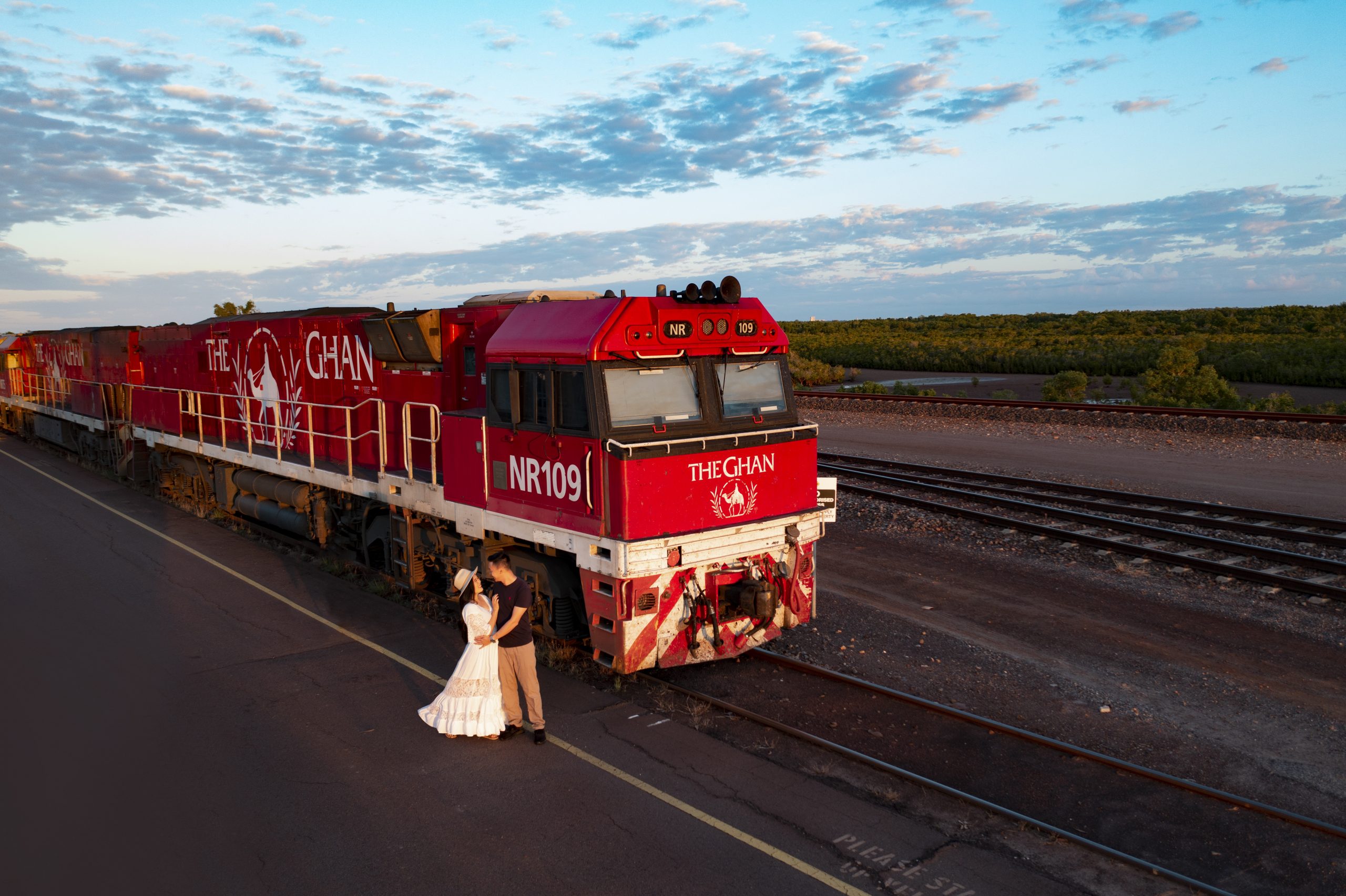 Couple on a platform in front of the Ghan